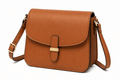 Brown leather handbag with a gold buckle on a white background